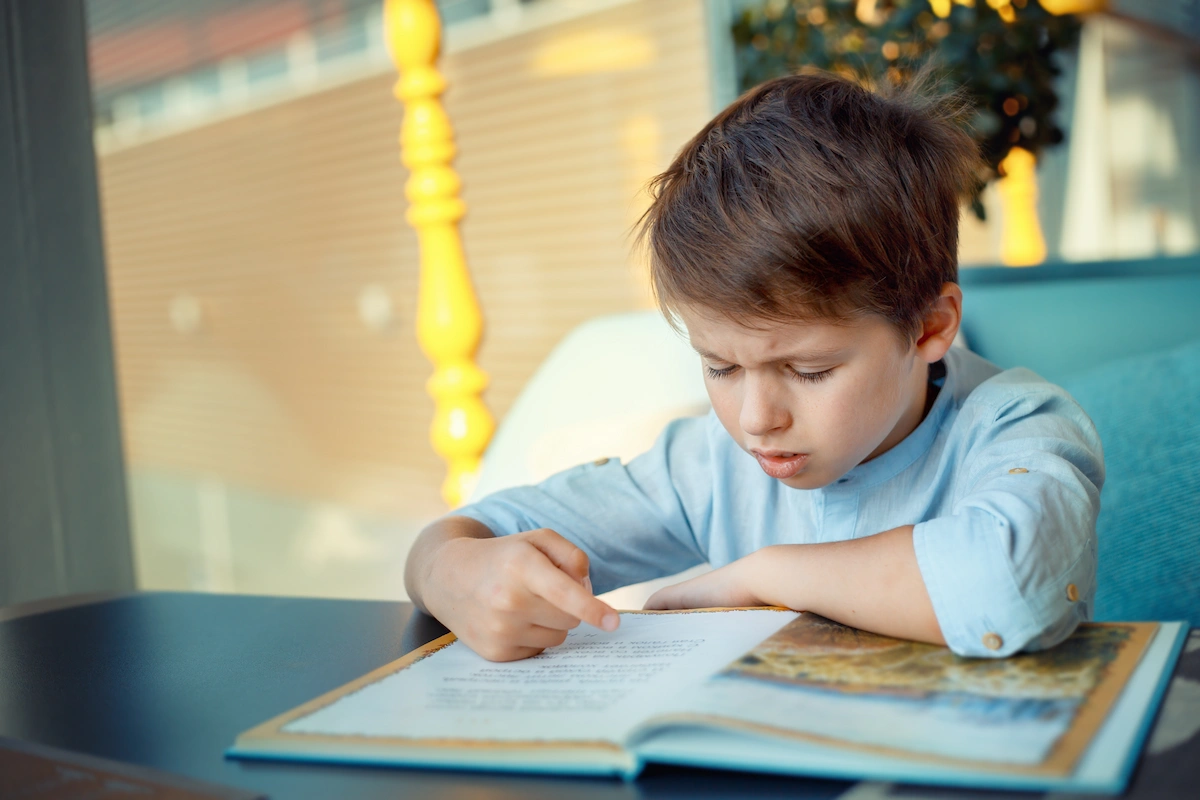 Child experiencing difficulty reading book